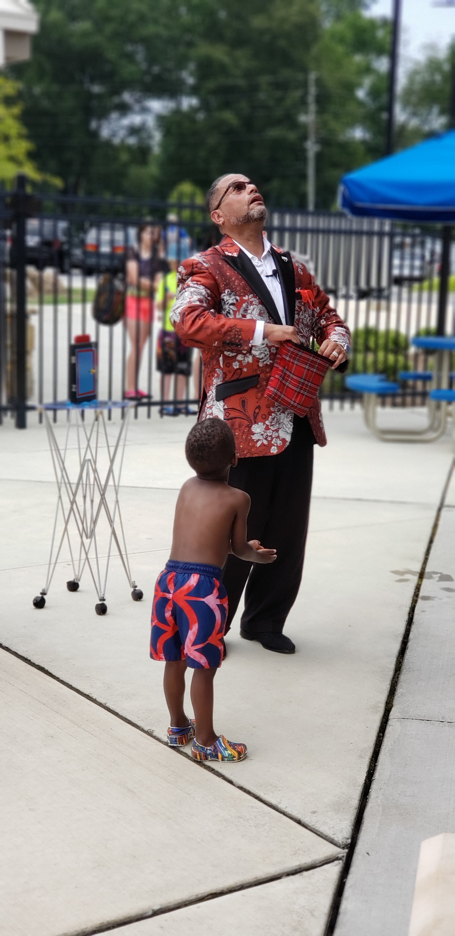 C. Magic performing outdoors with child