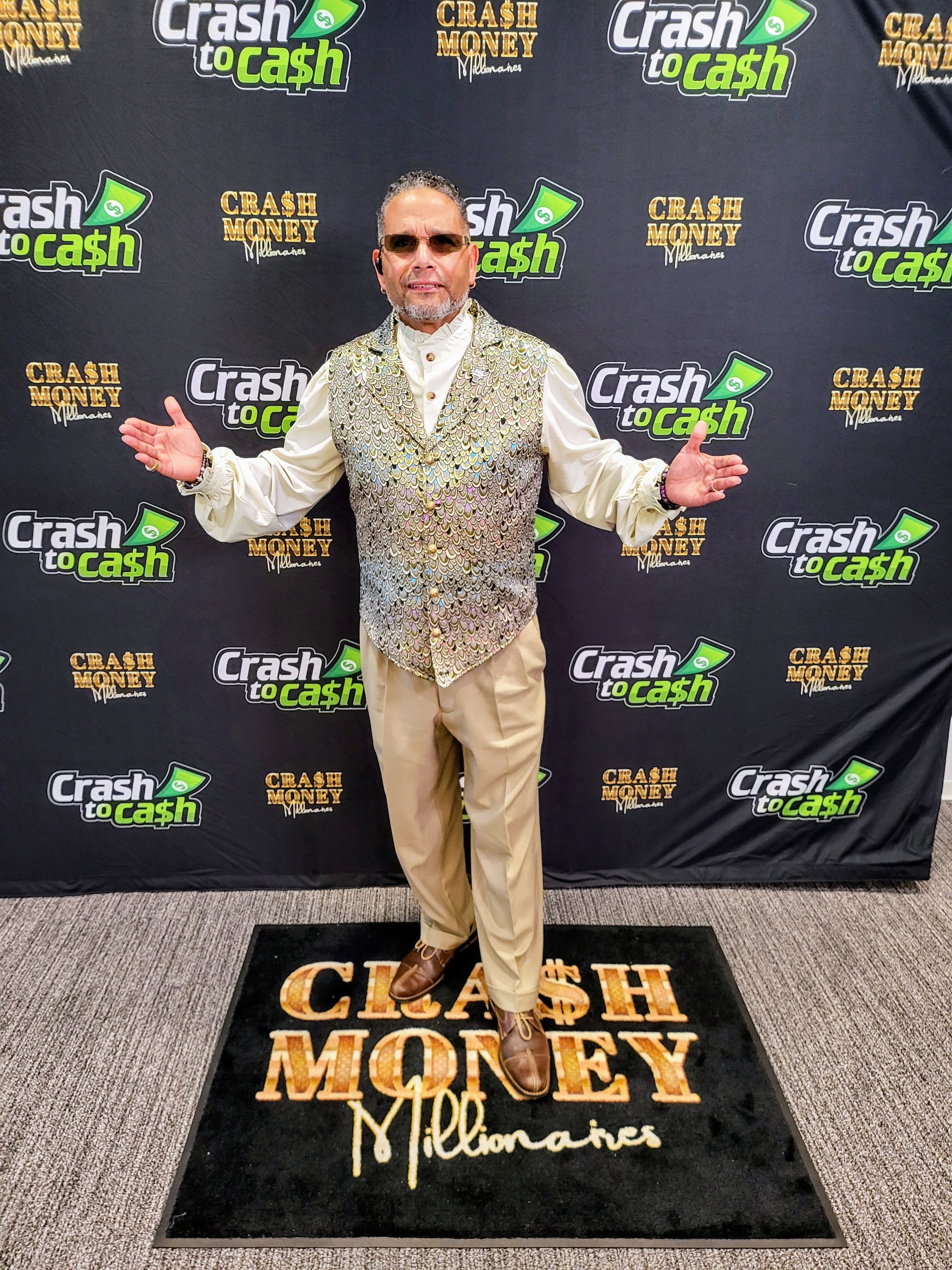 C. Magic posing at Crash to Cash Millionaires event backdrop