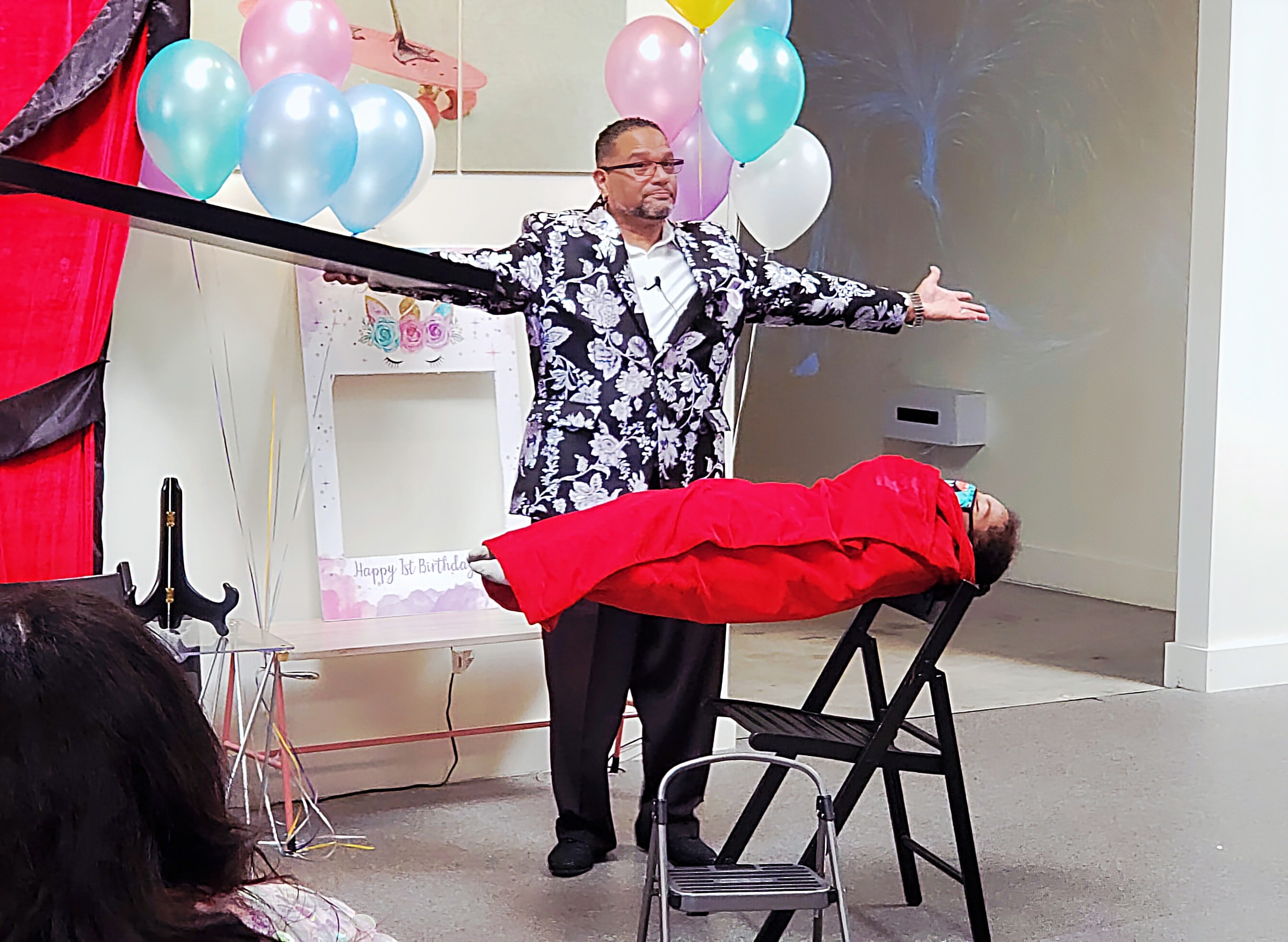 C. Magic performing levitation illusion at birthday party