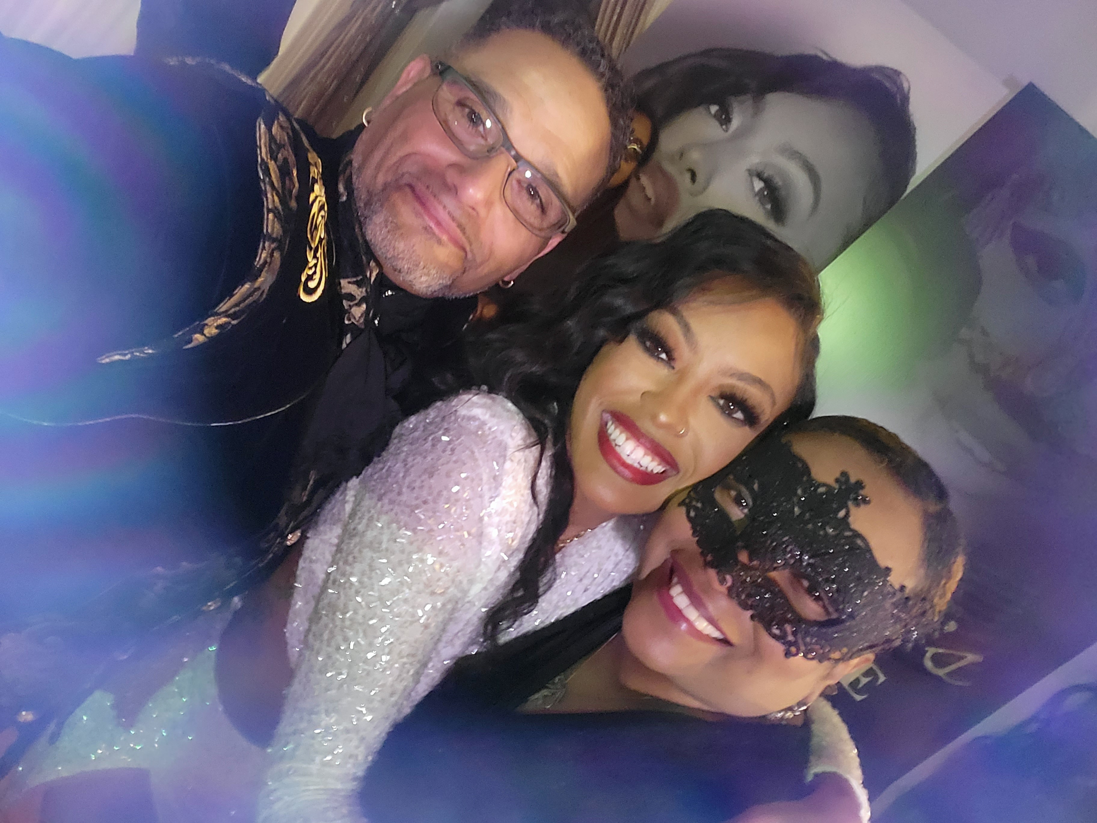 C. Magic group photo at masquerade event