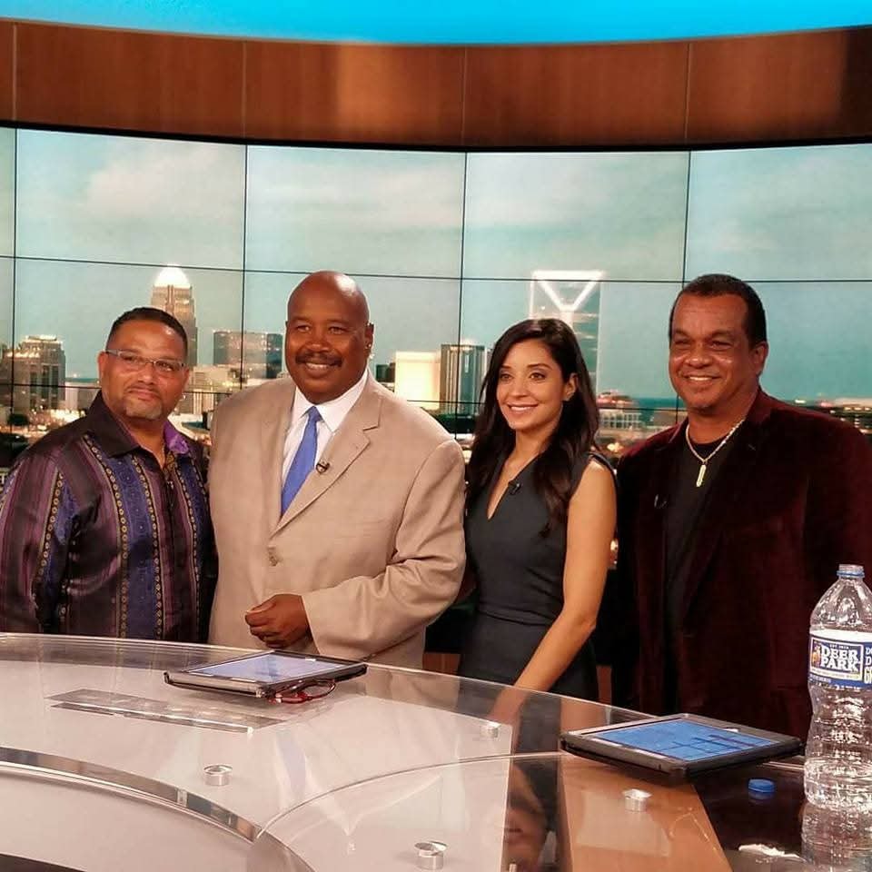 C. Magic with team on TV news set